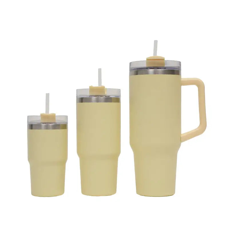Set of three yellow insulated tumblers with handles and straws on a white background
