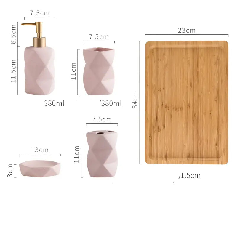 Pink bathroom accessory set with wooden tray.