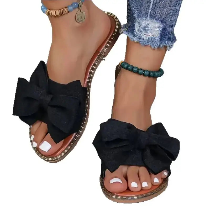 Black bow-adorned sandals.
