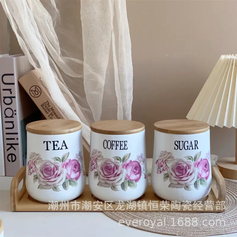 Floral-decorated tea, coffee, and sugar canisters.