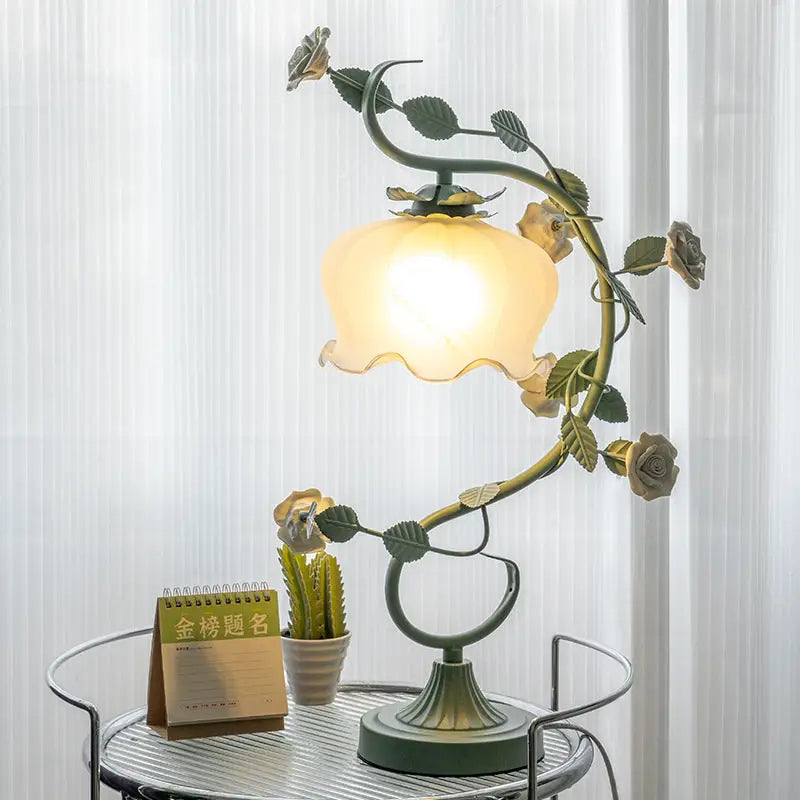 Floral-themed table lamp with a glowing shade.
