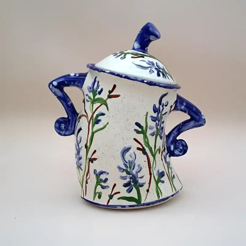 Hand-painted ceramic sugar bowl with lid.