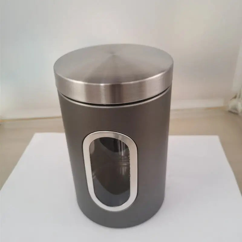 Gray canister with a silver lid and window.