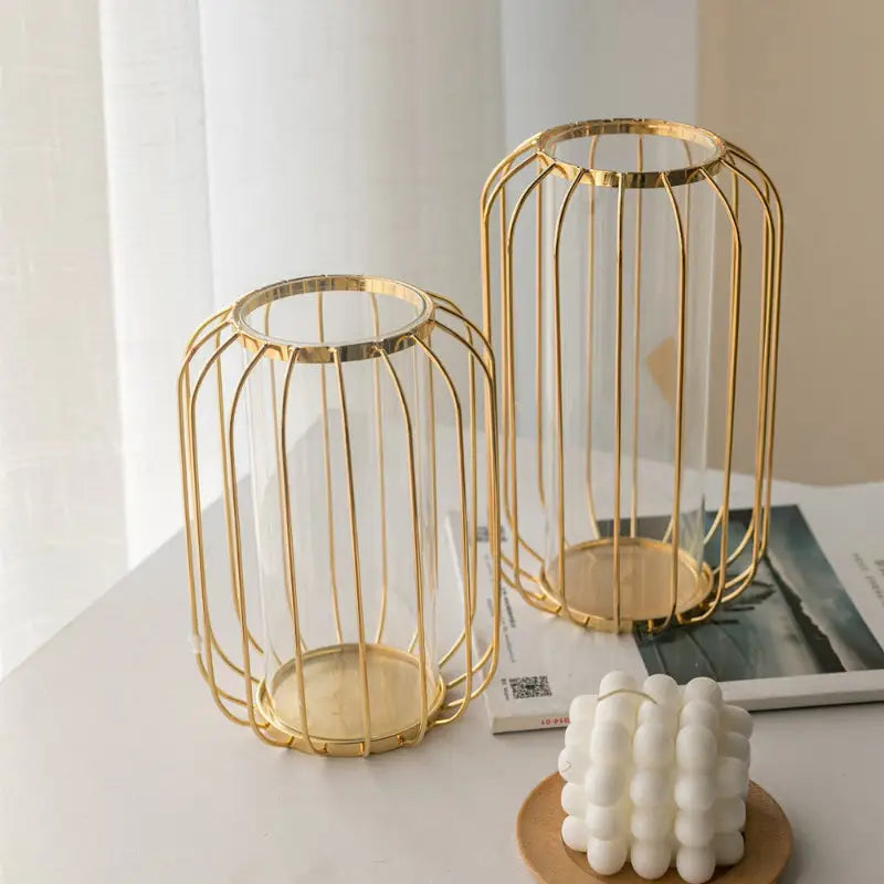 Two gold metal candle holders.