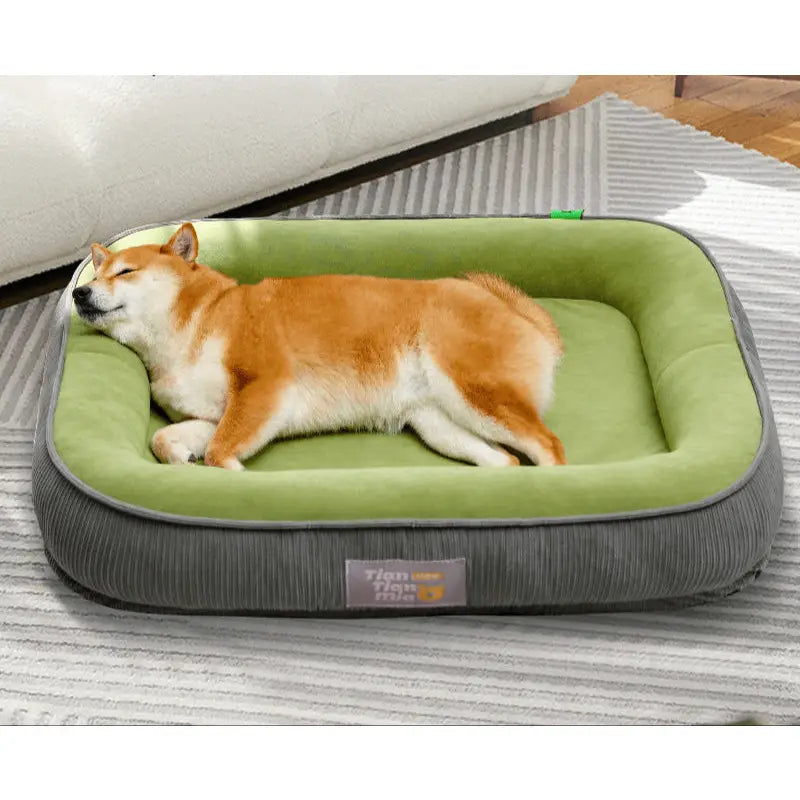 Dog sleeping in a cozy green and gray pet bed for a happy furry friend