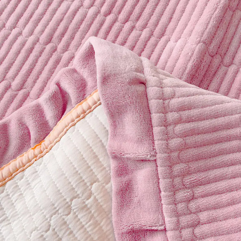 Pink textured blanket with white quilted lining.