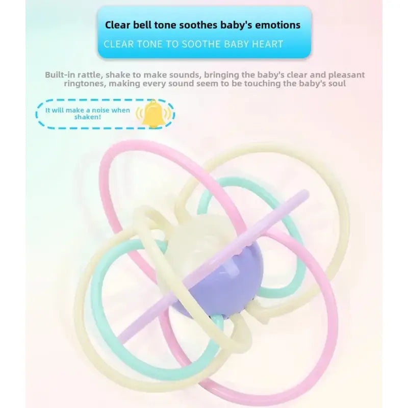 Baby rattle with pastel-colored rings on a light pink background