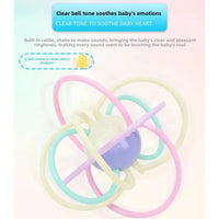 Baby rattle with pastel-colored rings on a light pink background