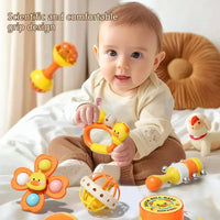 Baby playing with colorful toys on a bed