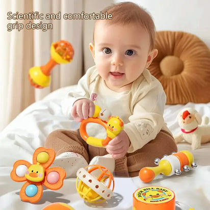 Baby playing with colorful toys on a bed
