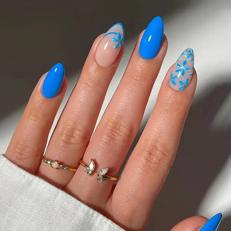 Hand with blue and floral nail art.