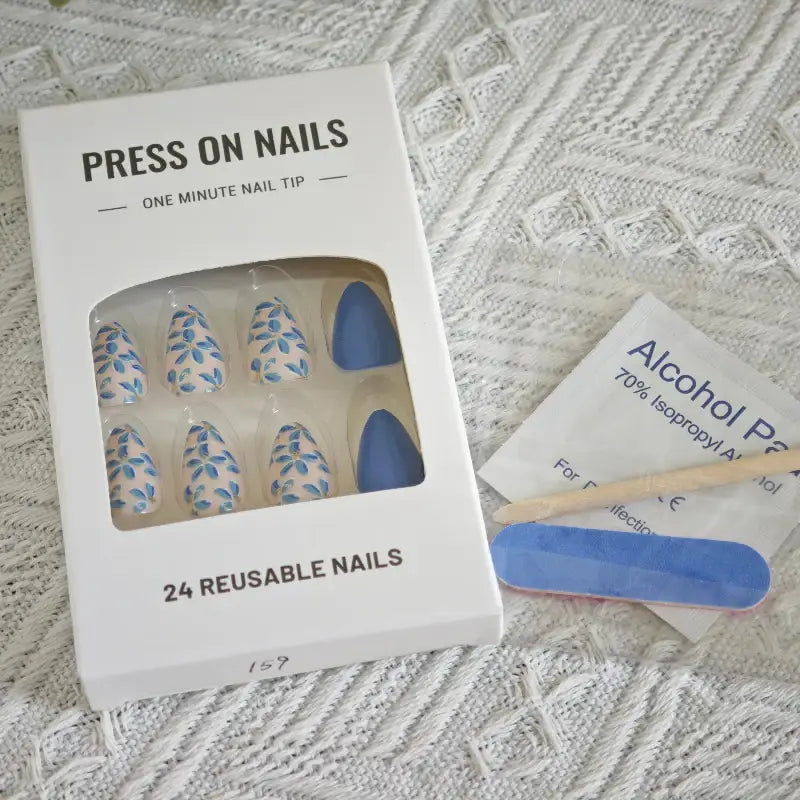 Press-on nail kit with floral and solid blue designs.