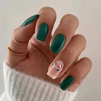 Hand with green and floral nails.