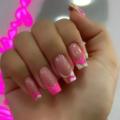 Hand with pink and white nail art.