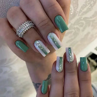 Green and white manicured nails.