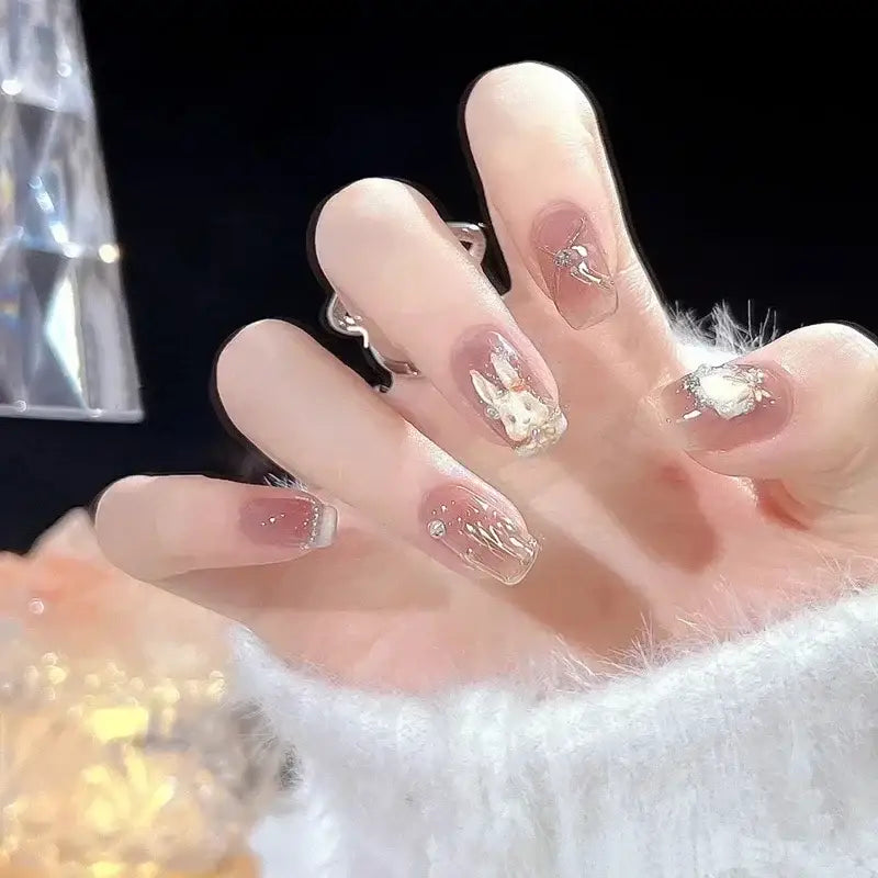 Elegant fingernails with bunny and heart designs.