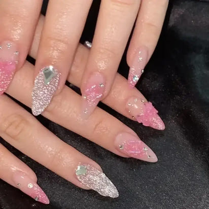 Elaborate pink and silver stiletto nails.