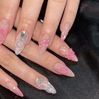 Elaborate pink and silver stiletto nails.
