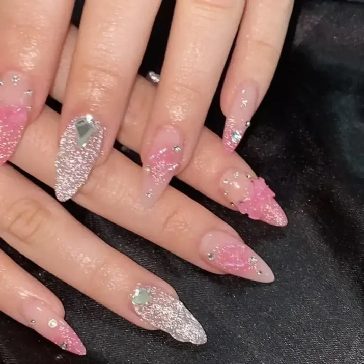 Elaborate pink and silver stiletto nails.
