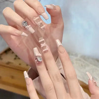 Elegant manicured hands with decorative nails.