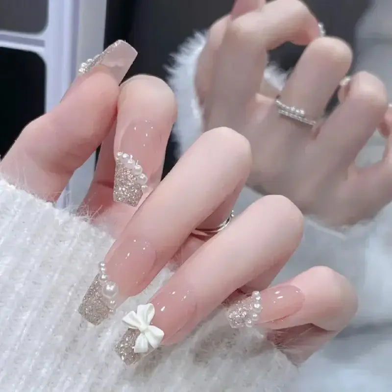 Elegant, long, decorated fingernails.