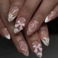 Elaborate nail art with bows and flowers.