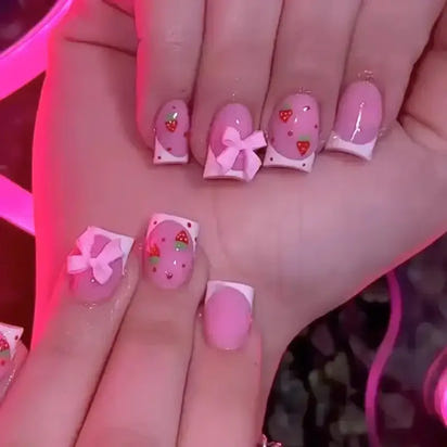 Pink strawberry-themed nail art.