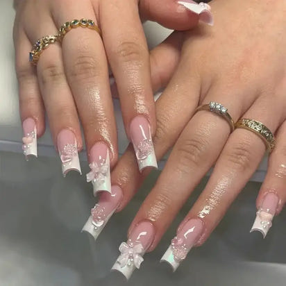 Elaborate, floral-accented French manicure.