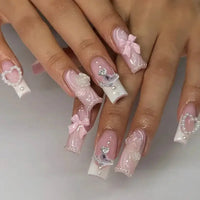 Elaborate pink and white nail art.