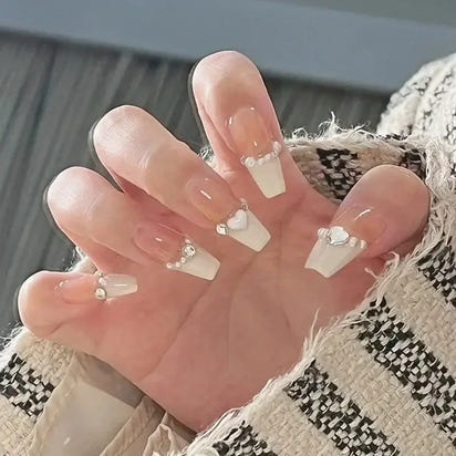 Hand with long, decorated nails.