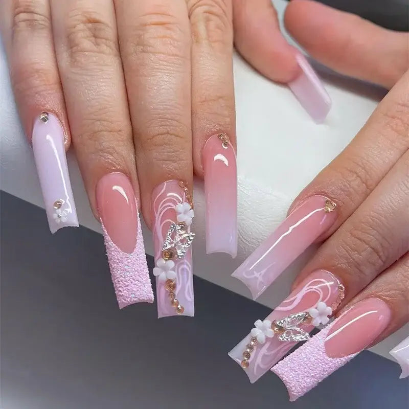Elaborate, decorated, pink and white acrylic nails.