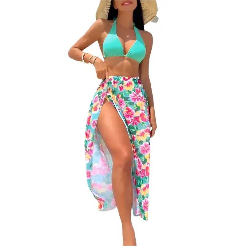 Woman in a turquoise bikini and floral sarong.