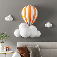 Wall-mounted hot air balloon and cloud decor.