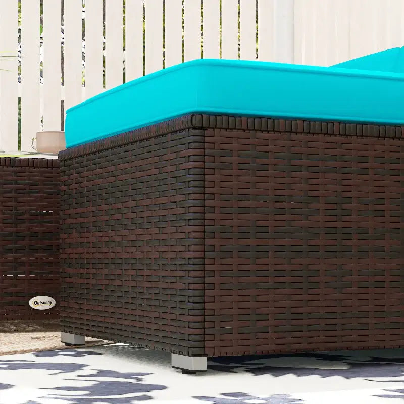 Wicker patio furniture with turquoise cushions, including a three-seat sofa and coffee table
