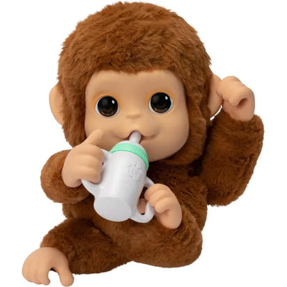 Stuffed monkey toy holding a baby bottle with a white cap on a white background