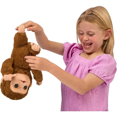 Child playing with a monkey toy on a white background