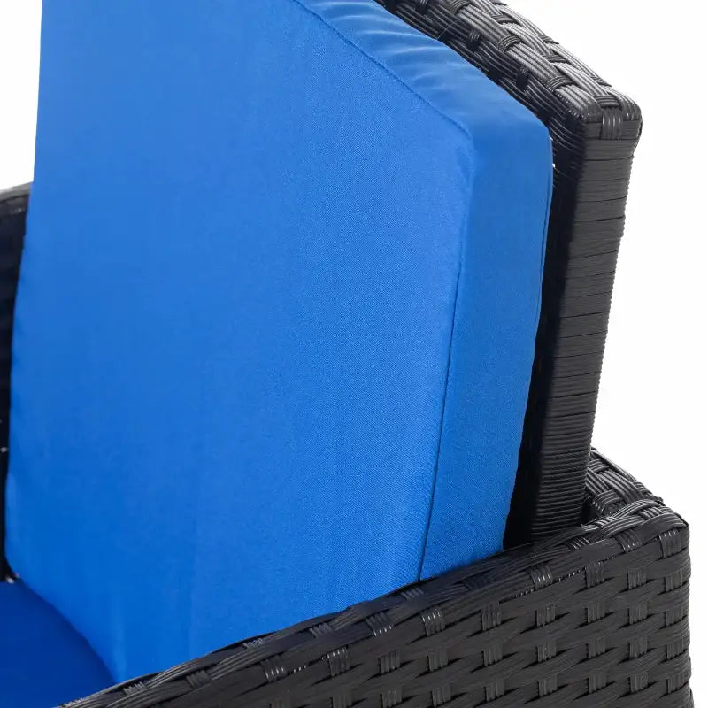 Blue cushioned wicker chair from the 9-Piece Wicker Patio Dining Set for outdoor relaxing