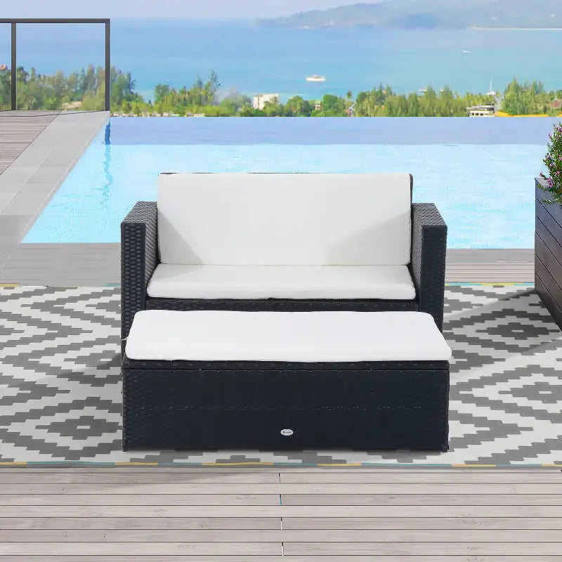 Wicker patio set with white cushions featuring a piece wicker couch and ottoman set