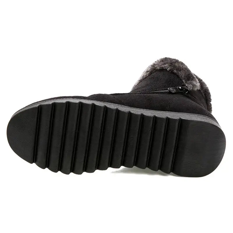 Black winter boot with fur trim on a white background