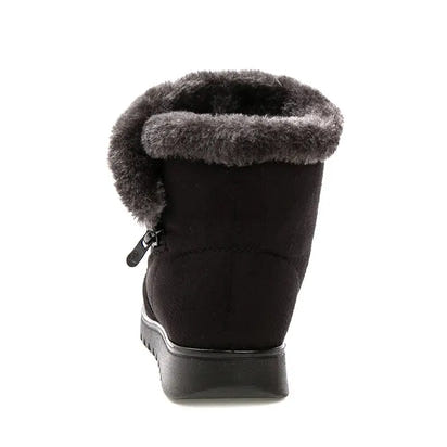Black winter boot with gray fur lining on a white background