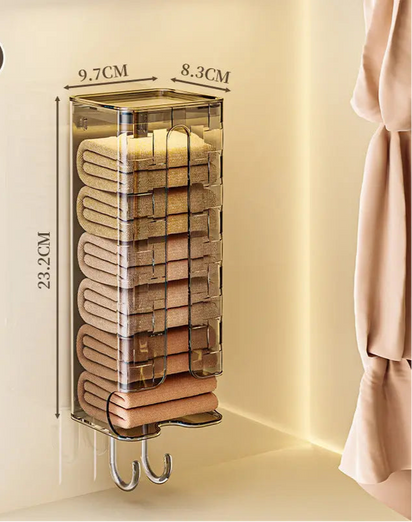 Wall-mounted towel organizer with folded towels inside, showing dimensions, on a neutral background.