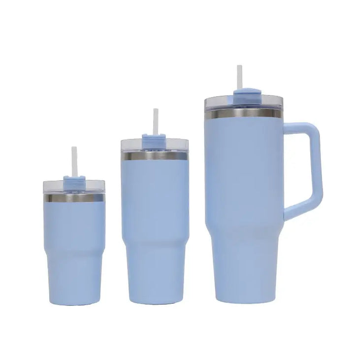 Set of three light blue insulated tumblers with straws on a white background