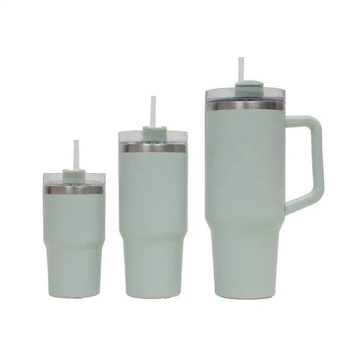 Set of three mint green insulated tumblers with straws on a white background