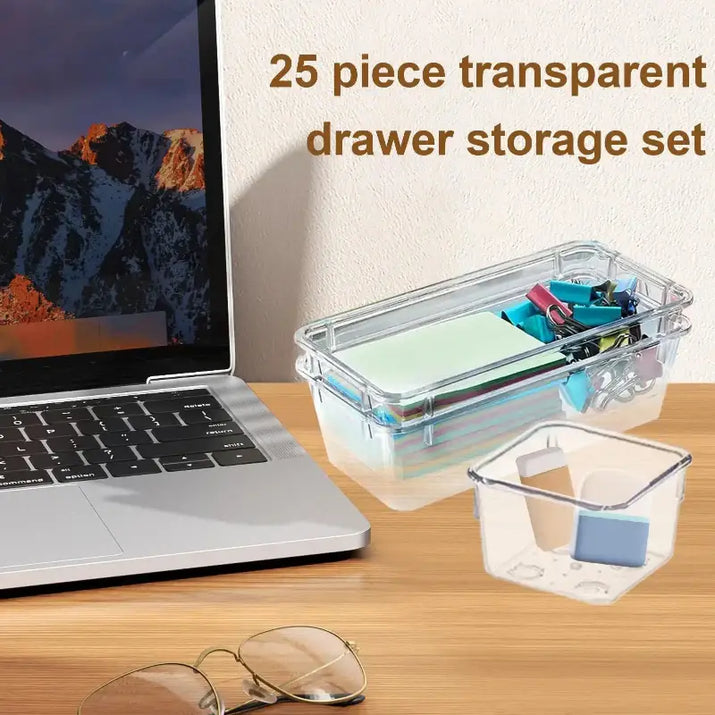 25 piece transparent drawer storage set on a desk with a laptop and glasses.