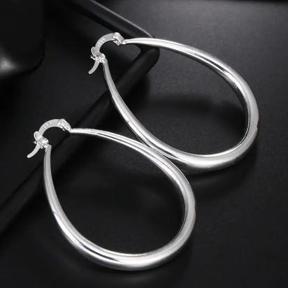 Sterling silver hoop earrings featuring a teardrop design, perfect for stylish earrings