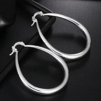 Sterling silver hoop earrings featuring a teardrop design, perfect for stylish earrings