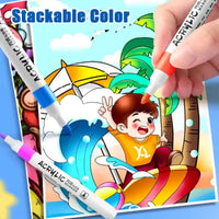 Coloring book with a child at the beach and acrylic markers being used to color it.