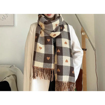 Person wearing a plaid scarf with heart patterns indoors.