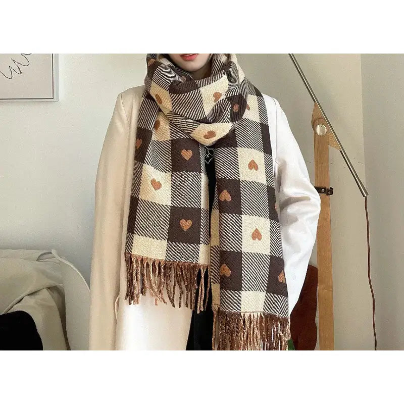 Person wearing a plaid scarf with heart patterns indoors.