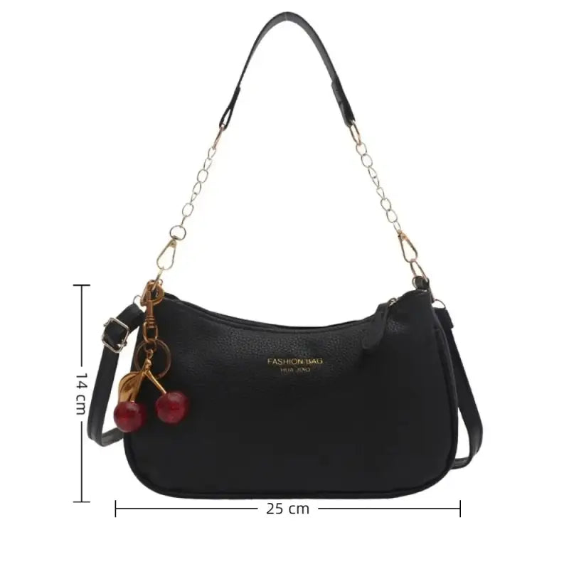 Black handbag with cherry charm and measurement details on a white background